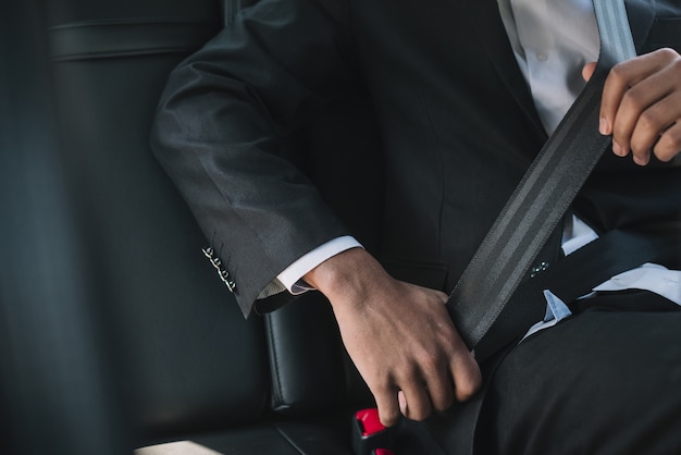 Unrecognizable man wearing seatbelt