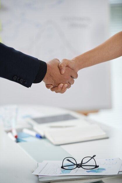 Unrecognizable Man And Woman Shaking Hands At Meeting Start