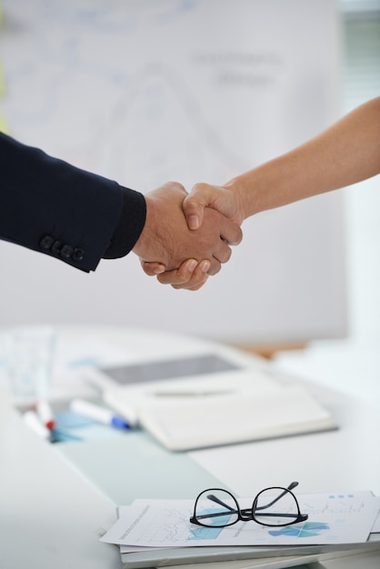 Unrecognizable Man And Woman Shaking Hands At Meeting Start