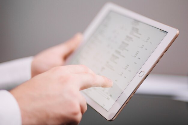 Unrecognizable office worker with tablet