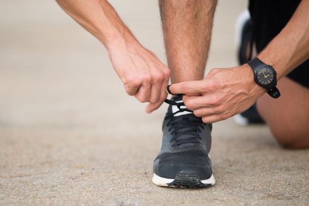 Unrecognizable runner preparing for jogging