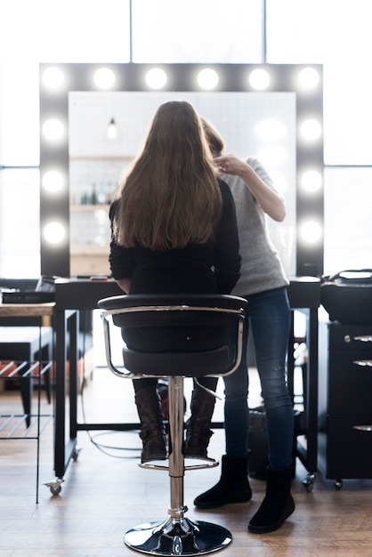 Unrecognizable stylist with client