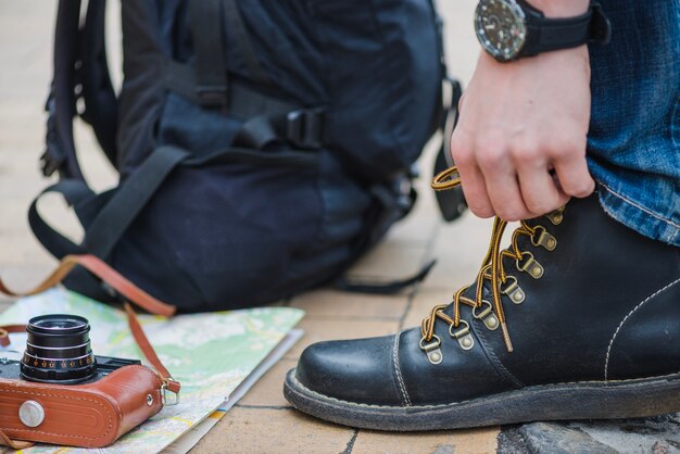 Unrecognizable tourist tightening laces