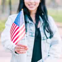 Free photo unrecognizable woman holding american flag during celebration of fourth of july