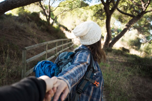 Unrecognizable woman offering to follow her