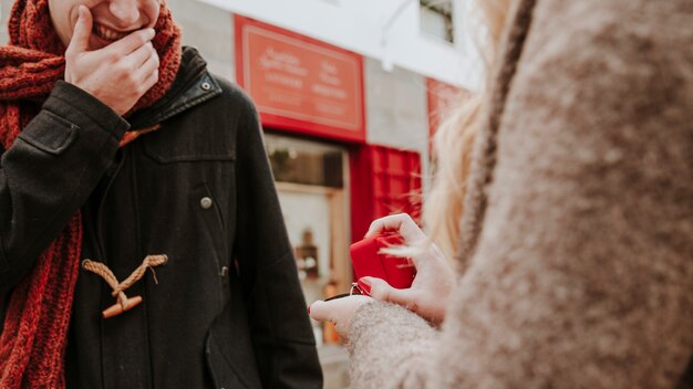 Unrecognizable woman proposing to man