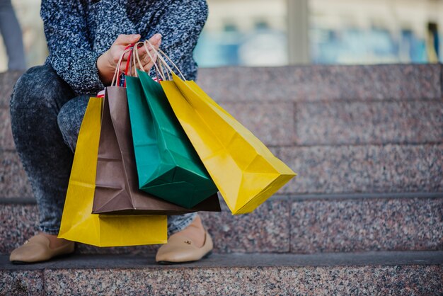 unrecognizable woman with shopping bags