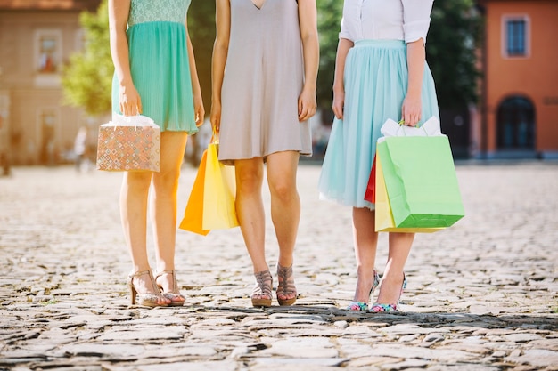 Unrecognizable women shoppers on street