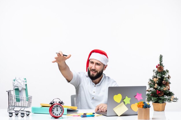 Unsatisfied young businessman in office celebrating christmas working