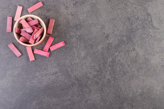 Unwrapped sugar free chewing gum sticks placed in a bowl.