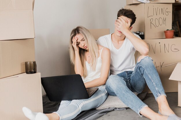 Upset couple sitting on the floor