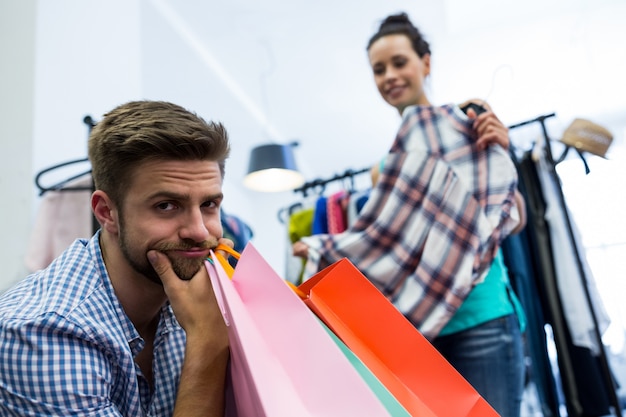 Upset man holding shopping bags