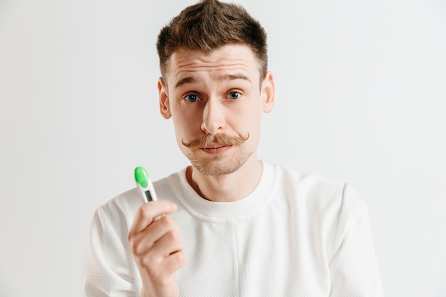 Free photo upset man looking in pregnancy test