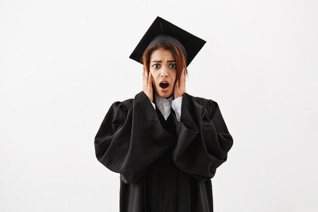 Upset surprised african female graduate.