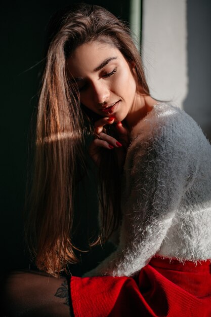 Free photo upset woman with long hairstyle posing with eyes closed