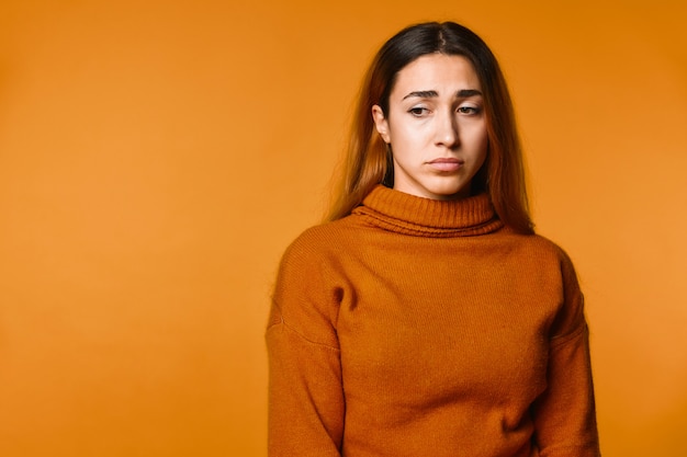 Upset young attractive caucasian girl dressed in pullover