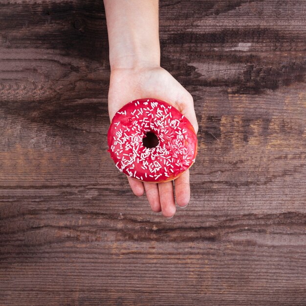 Upside down palm holding a doughnut