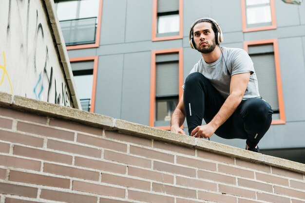 Urban athlete fastening his shoes