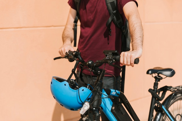 Бесплатное фото Городской велосипедист, идущий рядом с электронным велосипедом