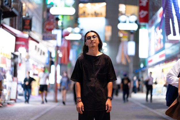 Urban portrait of young man with long hair