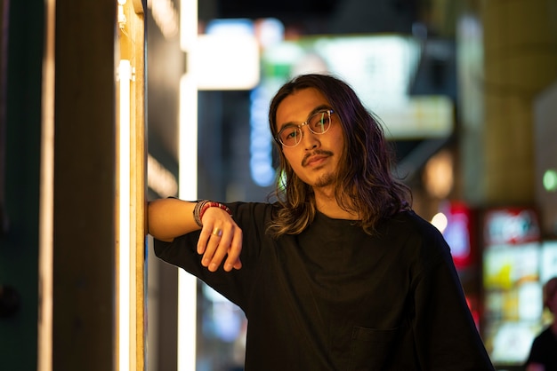 Urban portrait of young man with long hair