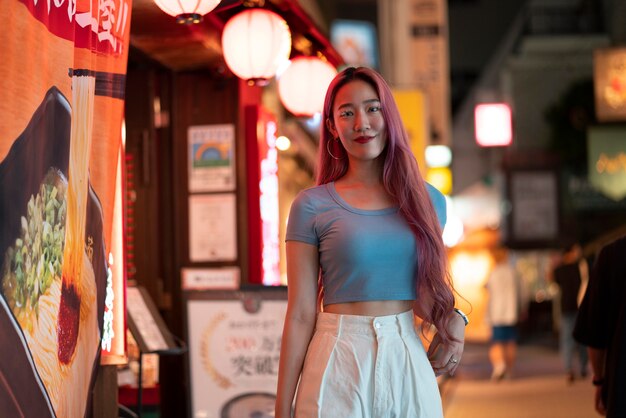 Urban portrait of young woman with long pink hair