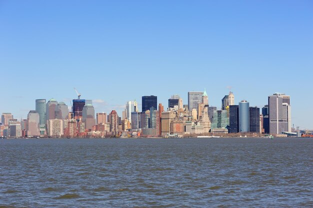 Urban skyscrapers of New York City Manhattan downtown over river.