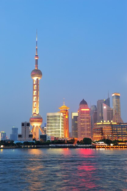 Urban skyscrapers in Shanghai at night over river