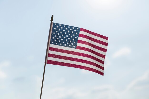 USA flag waving in breeze on sunny clear day