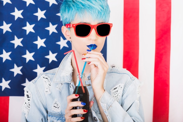 Usa independence day concept with punk woman drinking