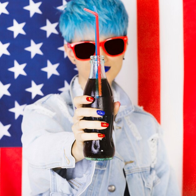 Usa independence day concept with punk woman holding bottle