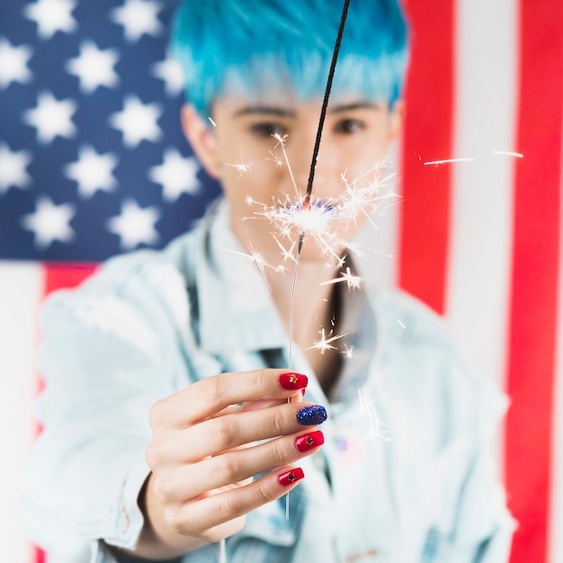 Usa independence day concept with punk woman holding sparkler