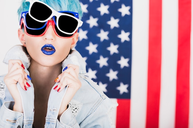 Usa independence day concept with punk woman with three sunglasses