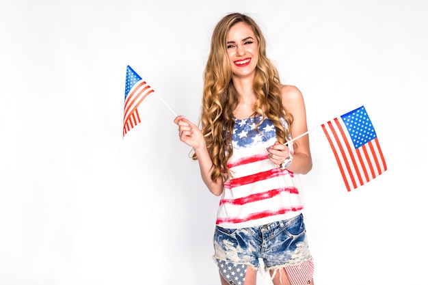 Usa independence day concept with woman holding small us flags