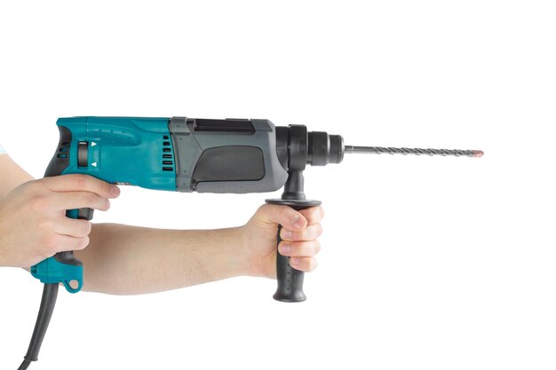 Use hammer drill to drill the wall