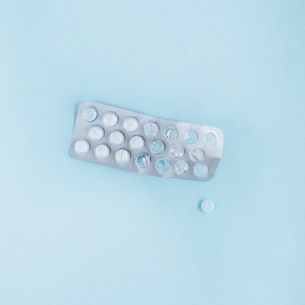 Free photo used blister pack with pills on blue background