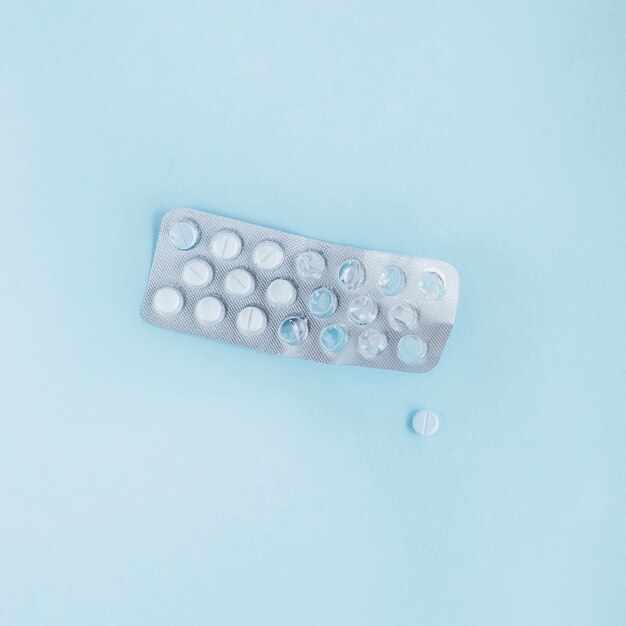 Used blister pack with pills on blue background