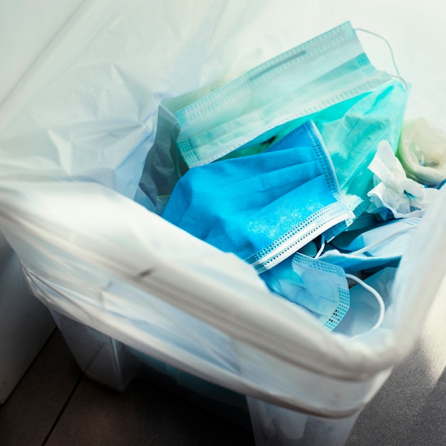 Free photo used face masks in a contaminated waste bin