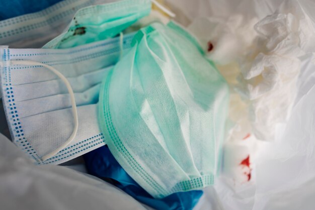 Used face masks in a contaminated waste bin