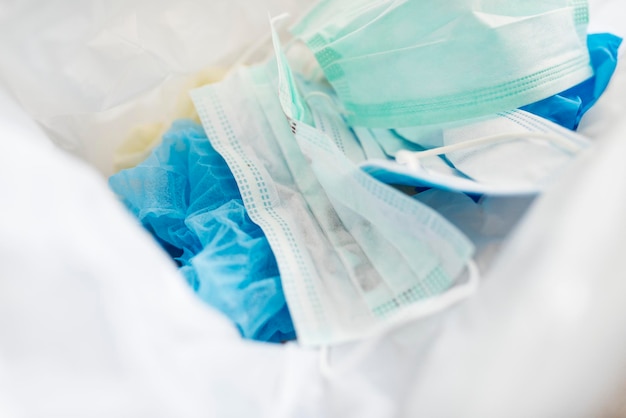 Used face masks in a contaminated waste bin