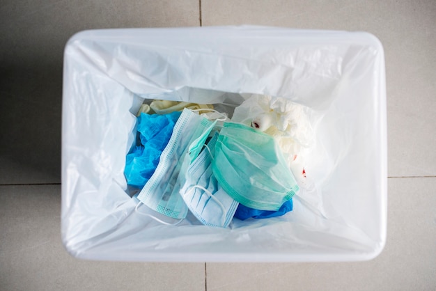 Free photo used face masks in a contaminated waste bin