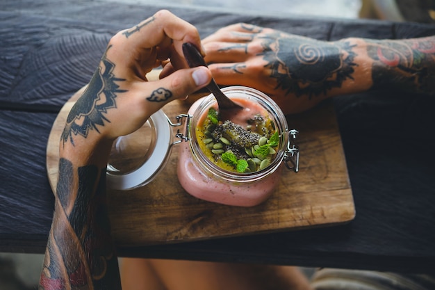 useful breakfast. a beautiful breakfast feed, men's hands in tattoos.