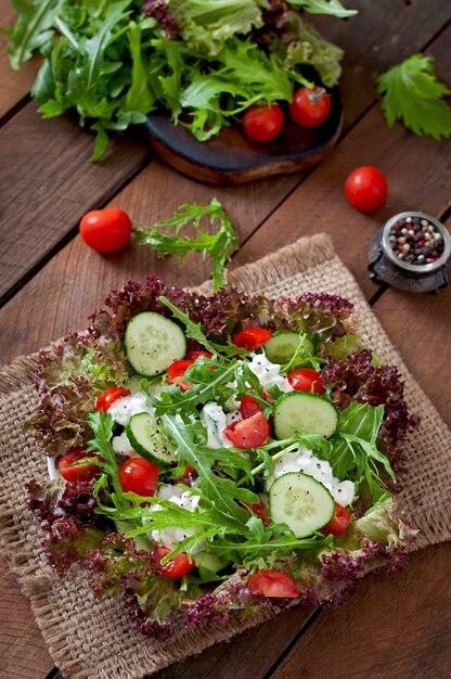 Useful dietary salad with cottage cheese, herbs and vegetables