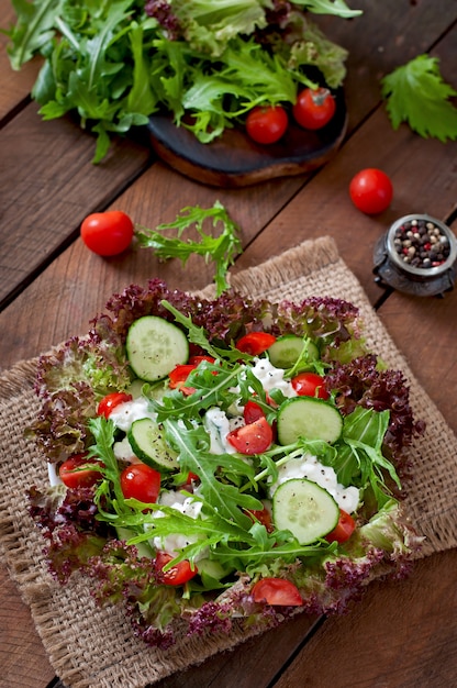 Useful dietary salad with cottage cheese, herbs and vegetables