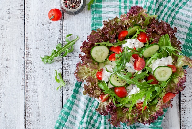 Useful dietary salad with cottage cheese, herbs and vegetables