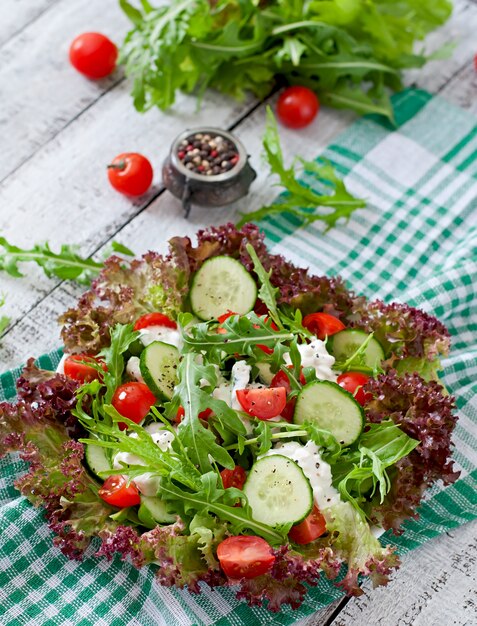 Useful dietary salad with cottage cheese, herbs and vegetables