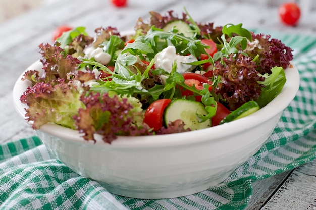 Useful dietary salad with cottage cheese, herbs and vegetables