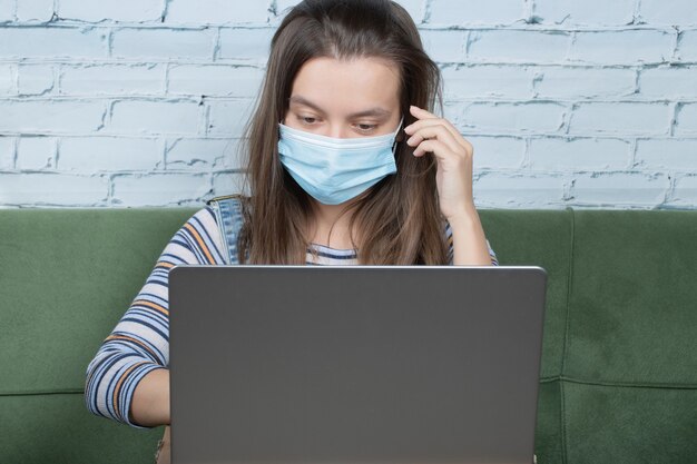 Using face mask while working with laptop in the office