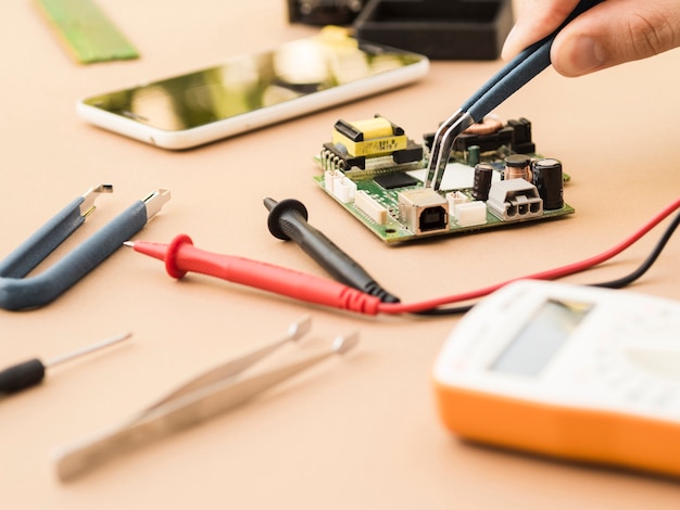 Free photo using pliers on a circuit board