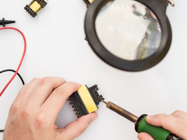 Free photo using soldering iron to fix a connector